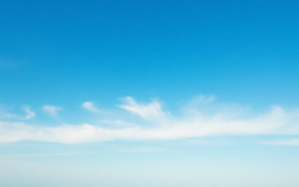 Bright blue sky with soft wispy clouds